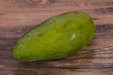 Green tasty mango over wooden background