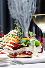 A modern dish with zander and vegetables. Table setting in luxurious restaurant.
