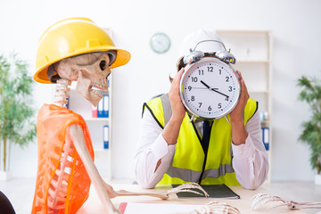 Funny construction business meeting with boss and skeletons