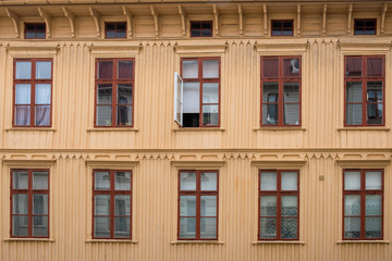 Wooden residential building with an open window