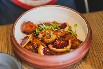 plate of chicken wings with blood oranges