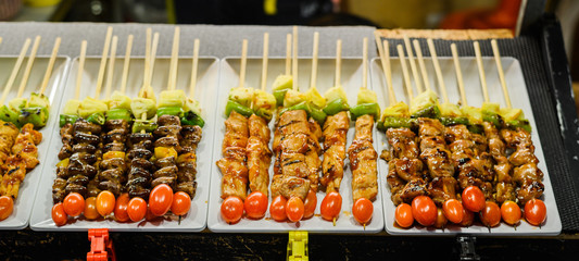 Night market street foods in Asia with varieties of barbecue for grill.