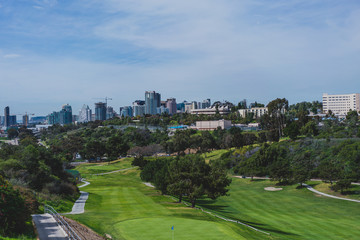 Fototapeta na wymiar golf course with city in background
