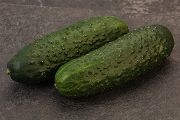 Green fresh cucumbers over background