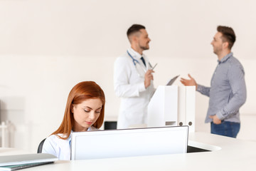 Female medical assistant working in clinic