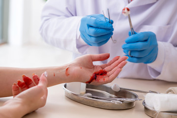 Hand injured woman visiting male doctor