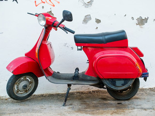Old classic red scooter parked