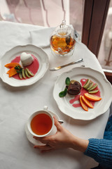 Beautiful smiling women drinking tea at cozy cafe.