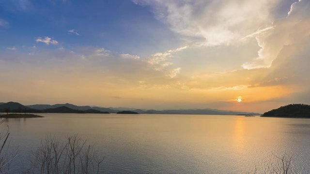 Time laps of small island in dam under cloudy sky at sunset time location at south of thailand