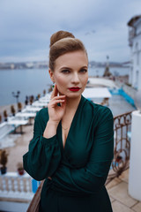 Beautiful young woman waiting for an event in a terrace restaurant.