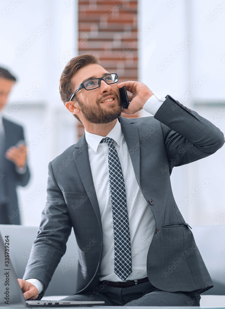 Sticker Confident young man talking on phone in office