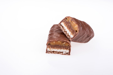 Chocolate peanut butter energy bar with peanuts isolated on white