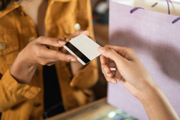 close up of hand giving credit card in the cashier before checkout
