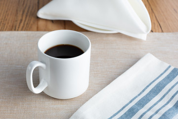 A view of a cup of coffee in a restaurant or kitchen setting.