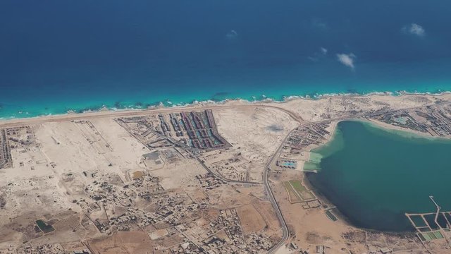 Earth's line. A perspective of the ground's colors and shapes. Aerial view of the Egyptian coast close to the town of Marsa Matruh. Overlooking the Mediterranean sea. View from the airplane window