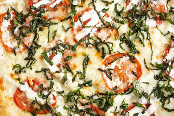 A top down view of a Margherita pizza pie, as a background.