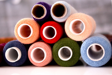 Stack of green, blue, rouge, red and other colored cotton threads for sewing clothes