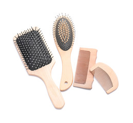 Hair brushes and combs on white background