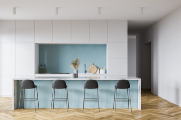 White and blue kitchen interior with bar