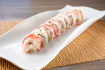 A view of an imitation crab roll sushi plate, in a restaurant or kitchen setting. © DAVID