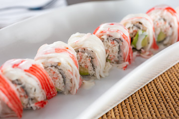 A view of an imitation crab meat roll plate, in a restaurant or kitchen setting. © DAVID