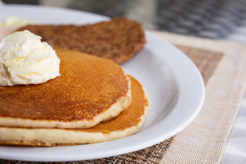 A closeup look at a plate of pancakes in a restaurant or kitchen setting.