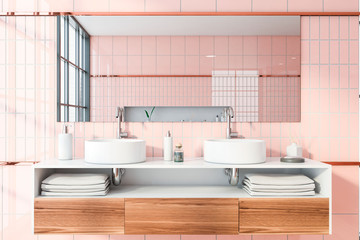 Double sink in pink tile bathroom