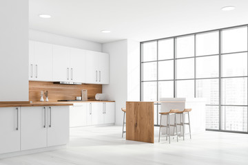 White and wooden kitchen corner with bar