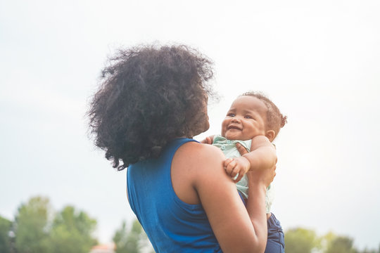 Happy African Mother Playing With Her Daughter Outdoor - Afro Mum And Child Having Fun Together - Family, Happiness And Love Concept - Soft Focus On Kid Face