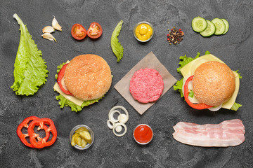 Fototapeta na wymiar Ingredients for tasty burger on dark background
