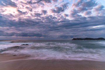 Fototapeta na wymiar Clouds and Surf - Sunrise at Malua Bay