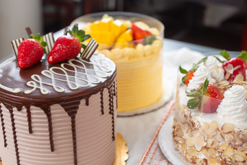 A view of several large cakes in a bakery setting.