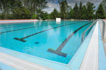 Swimmer in the Olympic swimming pool with clear blue water