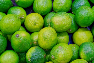lot of fresh green limes for eating as a background close - up