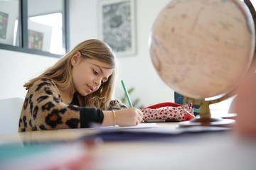 young girl doing her lessons at the home