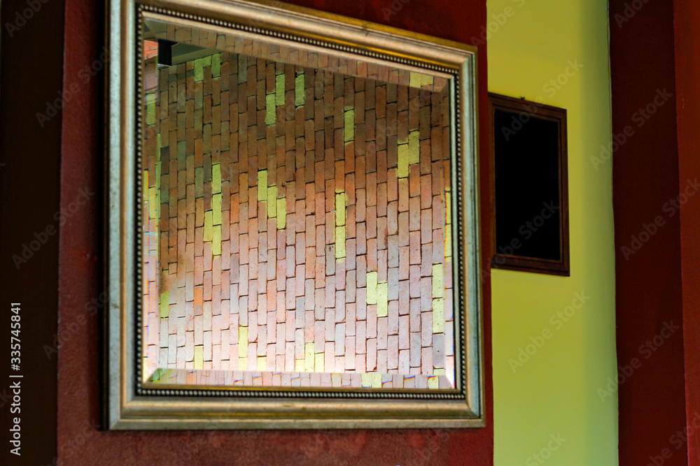 Wall mural picture frame with the brick wall reflection in the mirror