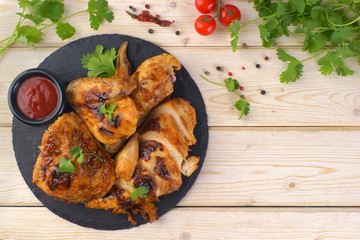 grilled chicken with barbecue sauce on a wooden background