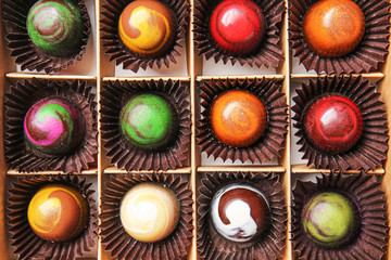 Box with delicious chocolate candies, closeup
