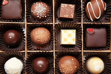 Box with delicious chocolate candies, closeup
