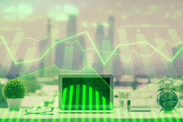 Forex graph hologram on table with computer background. Multi exposure. Concept of financial markets.
