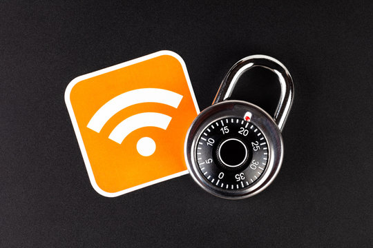 WiFi wireless network security simple abstract concept. Wifi Connection signal symbol and a coded padlock laying on black background. Securing, mobile internet data safety in public hotspots, hacking
