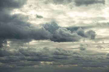 Fototapeta na wymiar Dramatic gray clouds in the pale sky