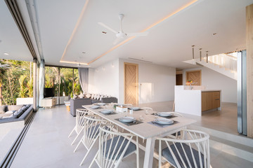 Interior design of dining area in pool villa, house, home, condo and apartment feature dining table, dining chair and open space living room