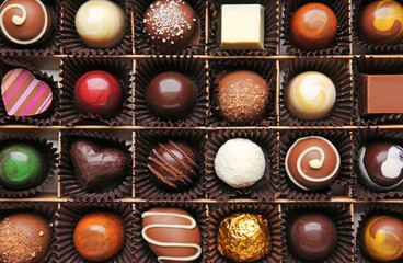 Box with delicious chocolate candies, closeup