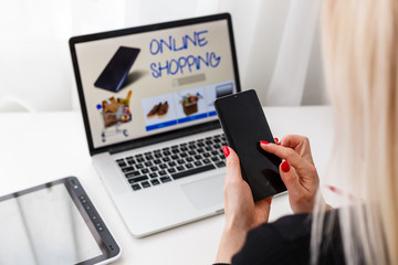 Woman shopping online using her laptop at home
