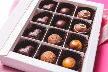 Box with delicious chocolate candies, closeup