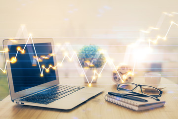 Forex graph hologram on table with computer background. Multi exposure. Concept of financial markets.