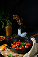 Spicy chicken wings in honey with potato wedges