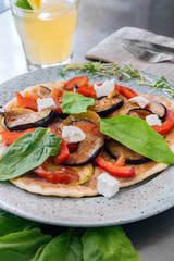 Pita bread sandwiches with grilled vegetables paprika, eggplant, tomato, basil and feta cheese served. Healthy fast food concept.