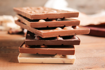 Sweet chocolate with nuts on wooden table